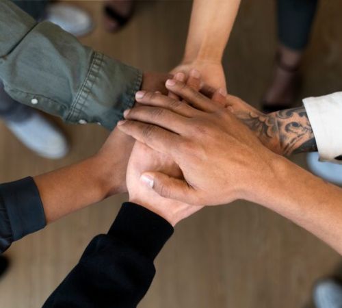 Team stacking hands together