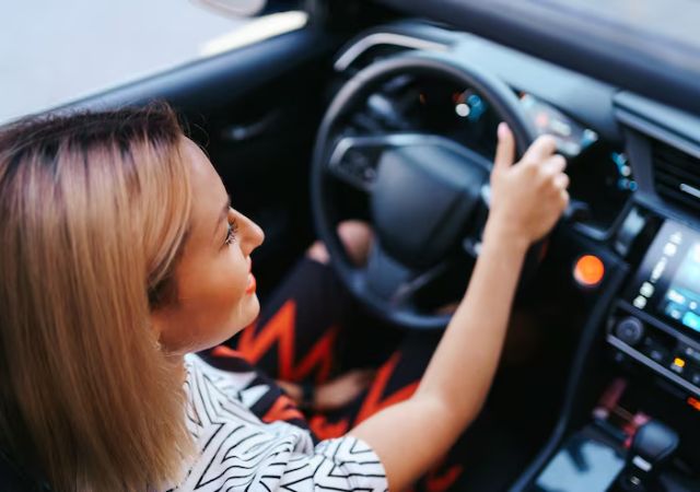 Driver adjusting the dashboard of a car